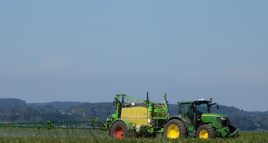 Tractor with field sprayer in an agricultural field
